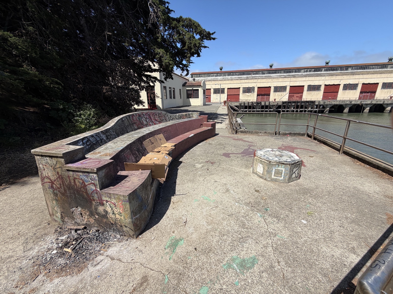 The bench today, with the Fort Mason warehouses and the Bay behind it.