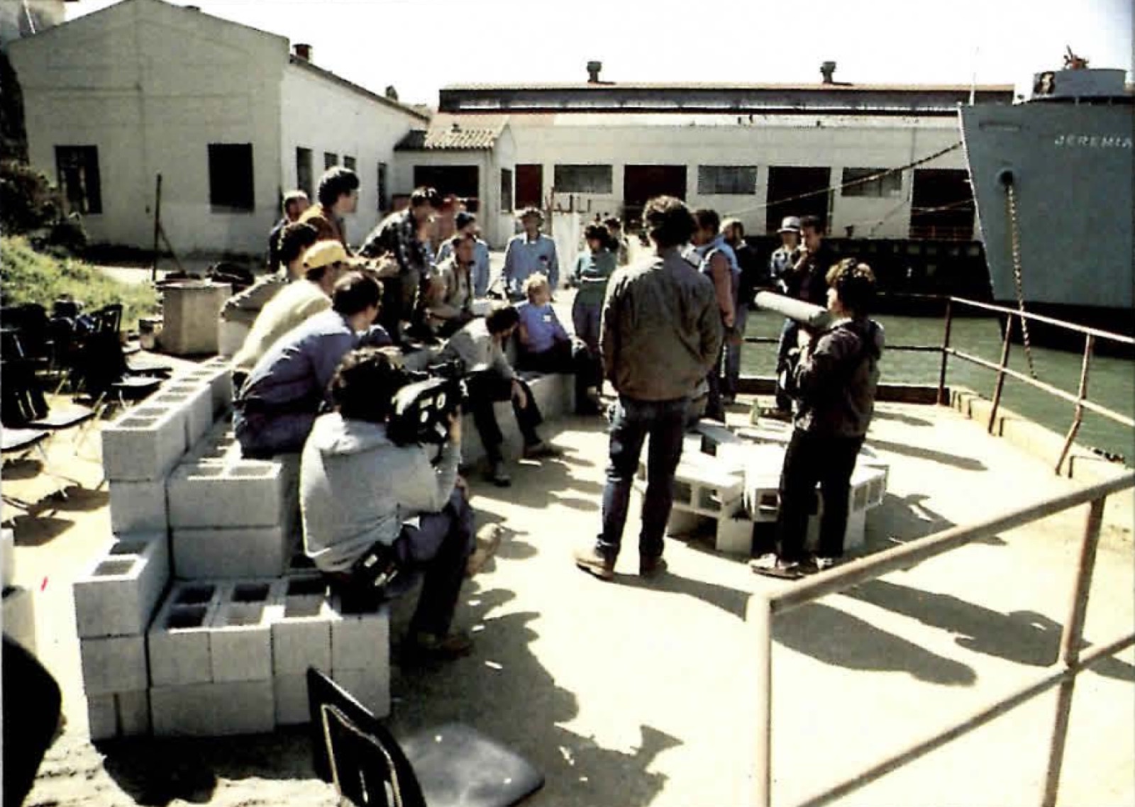 Workshop participants seated on a concrete-block mockup of the bench near the Fort Mason firehouse.